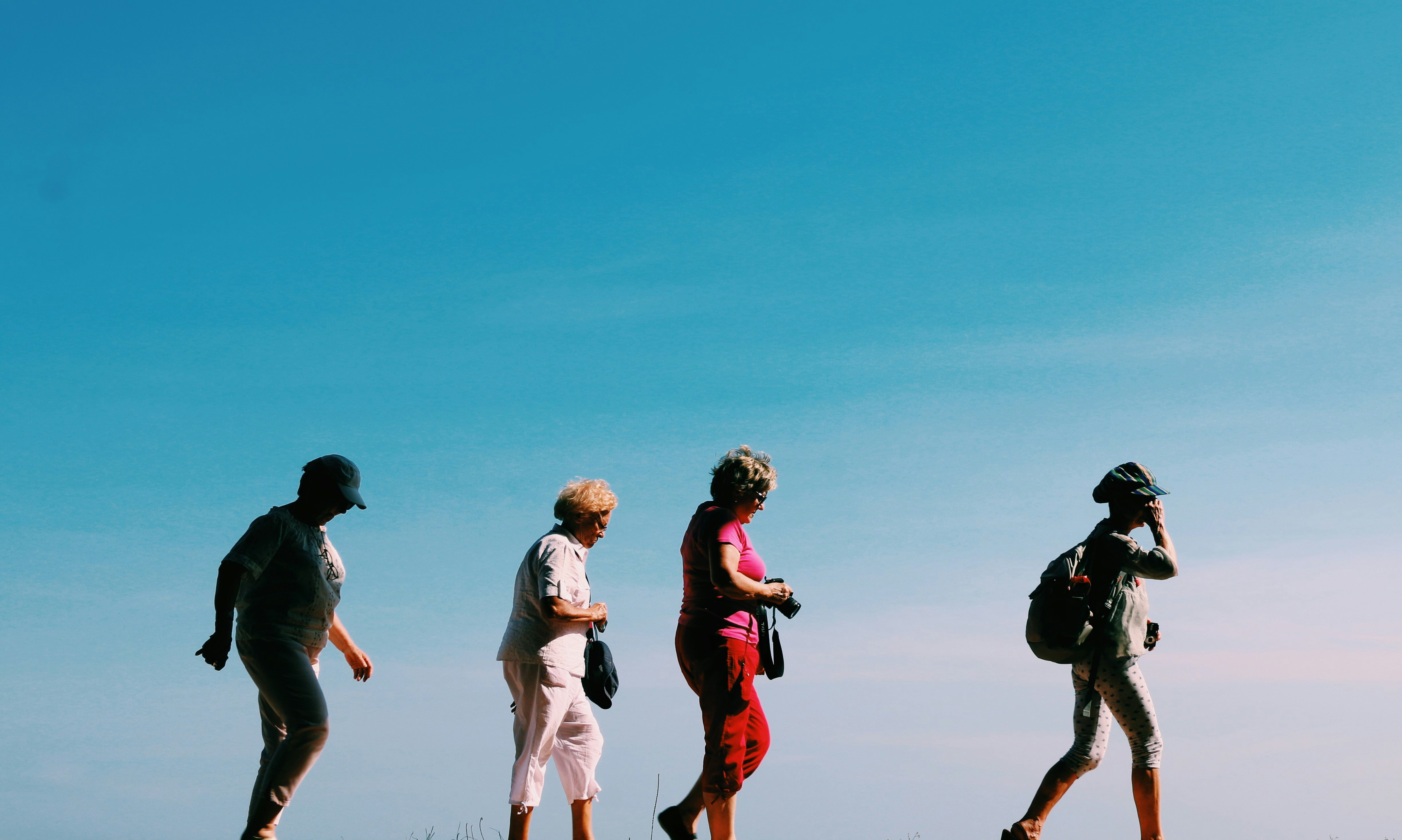 Tourists walking with a blue sky in the background.